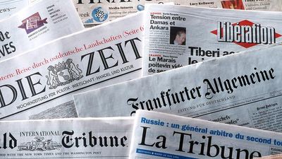 pile of international newspapers in various languages