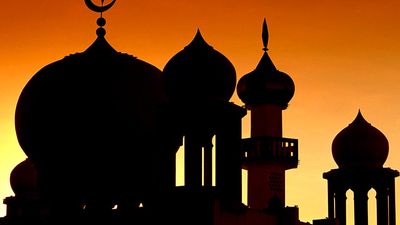 Domes of a mosque (muslim, islam) silhouetted against the sky, Malaysia.