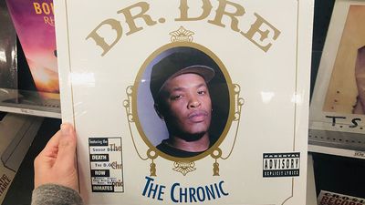 April 11, 2019 - Minneapolis, MN: Female Caucasian hand holds up a Dr. Dre The Chronic vinyl record album while shopping in a retail store, a classic retro 90s gangster rap album