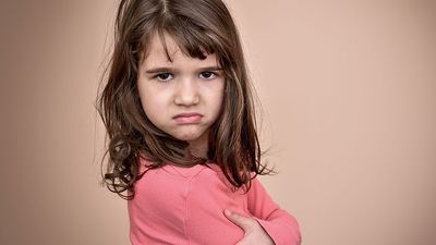 Frowning little girl. Angry annoyed