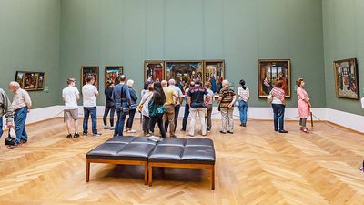 Visitors to the old Pinakothek in Munich admire the paintings of the great masters of antiquity