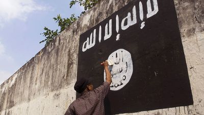 Government officials are erasing graffiti of Islamic State (ISIS) banner in Solo, Java, Indonesia.