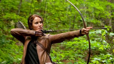 Jennifer Lawrence stars as Katniss Everdeen in The Hunger Games (2012) an science fiction adventure film directed by Gary Ross based on the novel by Suzanne Collins. archery bow and arrow