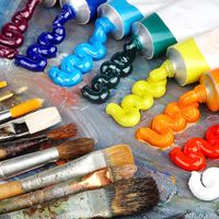 Painting palette with oil paints and brushes. Rainbow colored paints, arts and entertainment