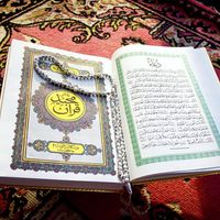 Prayer beads on Quran or Koran written in Arabic Islam's sacred and liturgical language. text, words, Ramadan