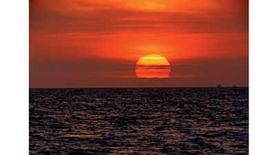 sun. Setting of the sun with evening light in the evening sky over water. Sunrise, sunset, star, orange, ocean, sea