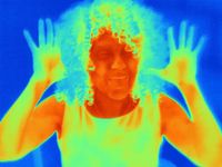 Thermal image portrait of mid adult woman with raised hands