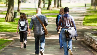 University Students Walking On Campus Road