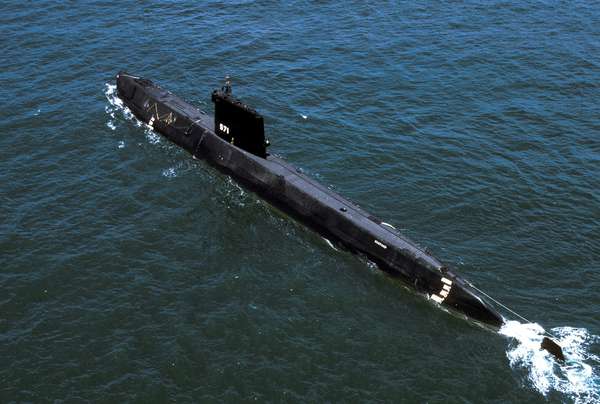 Aerial port quarter view of the world&#39;s first Nuclear-powered attack submarine ex-USS Nautilus (SSN 571) launched in 1954, being towed to Groton, CT to become a museum. USS Nautilus, submarine, navy, naval vessel.